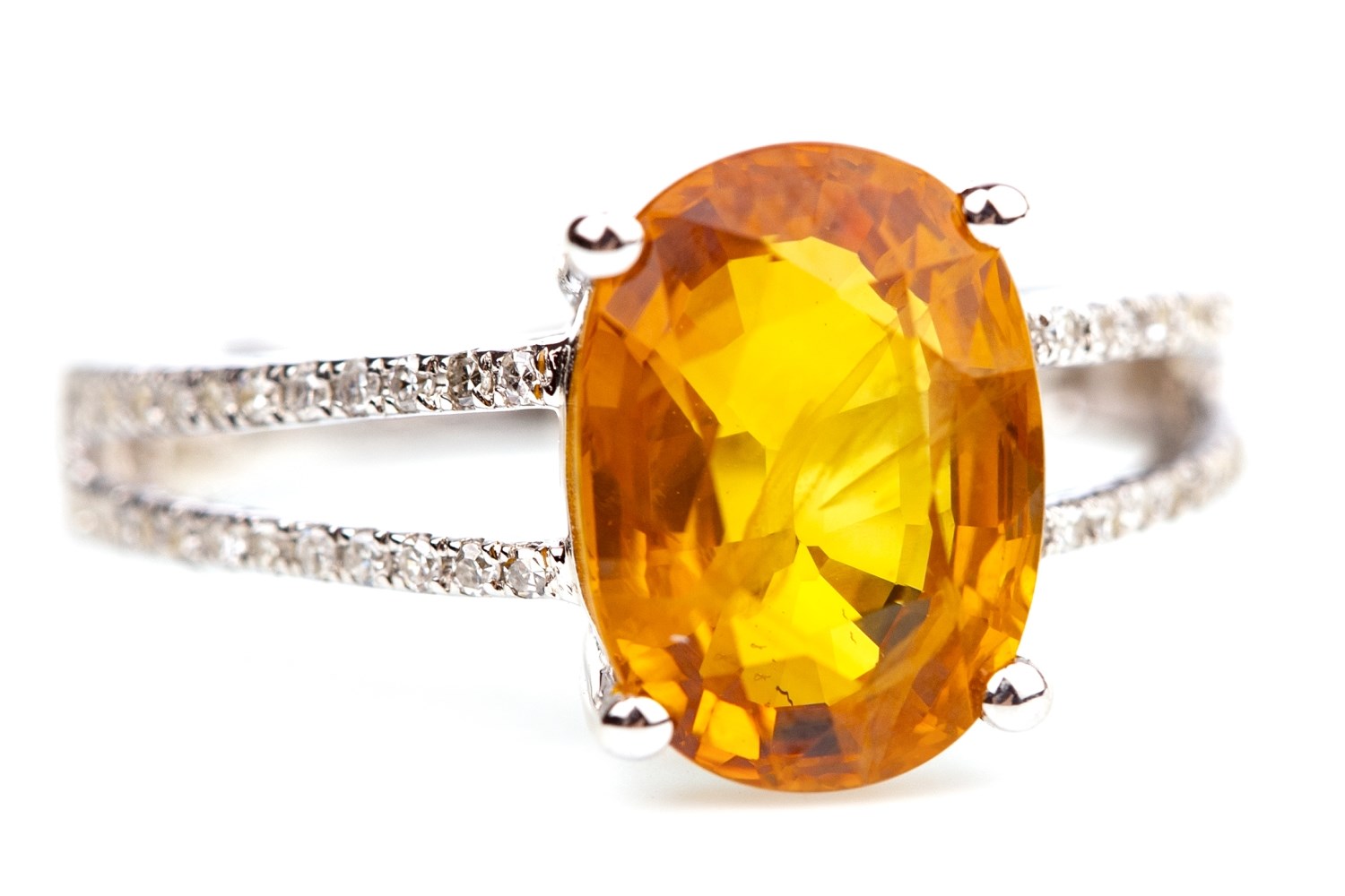 AN ORANGE GEM AND DIAMOND RING