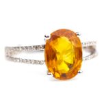 AN ORANGE GEM AND DIAMOND RING