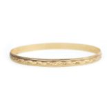 A NINE CARAT GOLD BANGLE