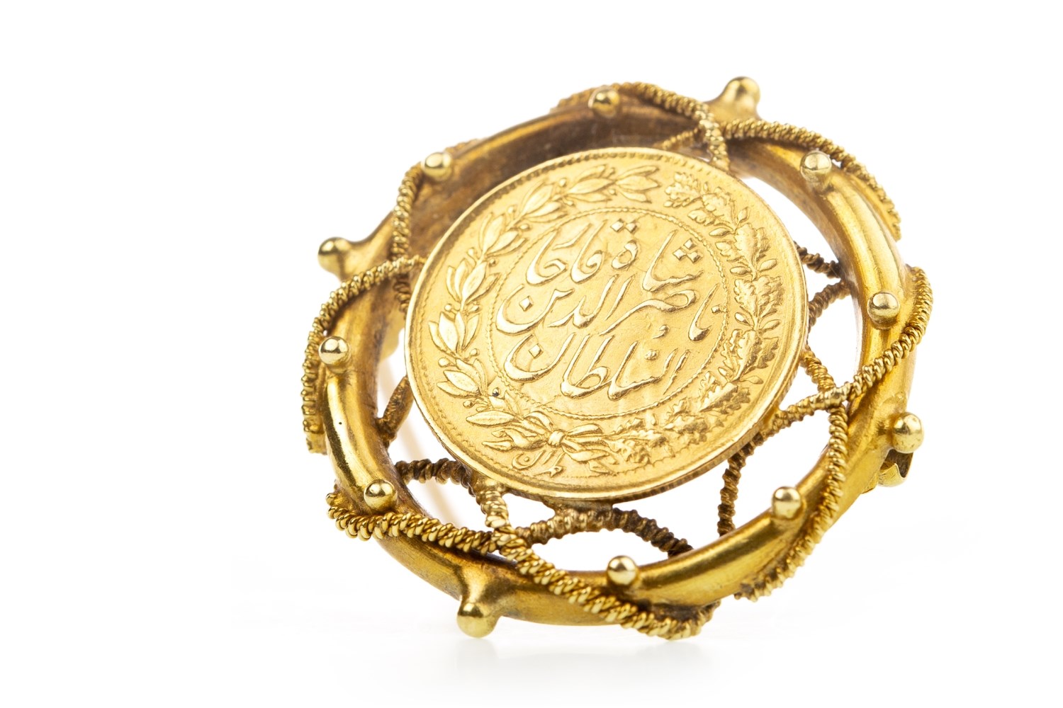 A PERSIAN COIN MOUNTED IN A BROOCH