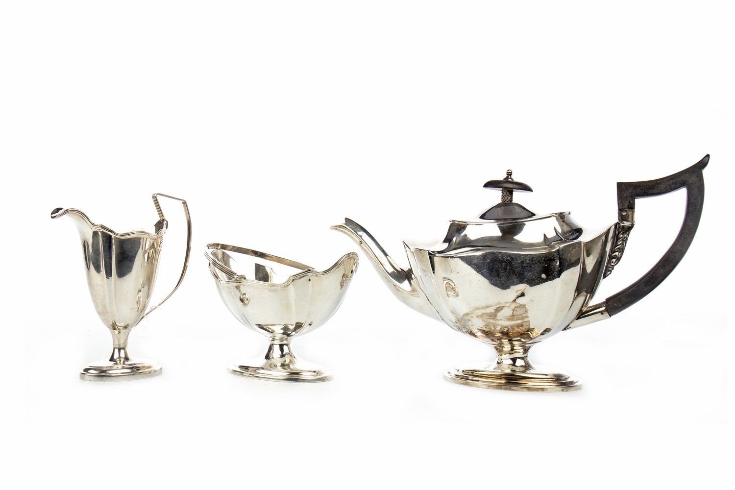 AN EDWARDIAN SILVER BOAT SHAPED TEA SERVICE