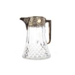 A SILVER PLATED AND CUT GLASS CLARET JUG