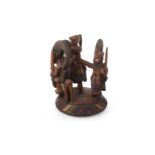 AN AFRICAN CARVED WOOD GROUP OF FIGURES