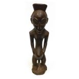 AN AFRICAN CARVED WOOD FIGURE