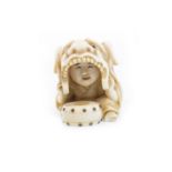 A JAPANESE IVORY NETSUKE OF A BOY