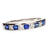 A SAPPHIRE AND DIAMOND HALF ETERNITY RING