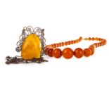 AN AMBER BEAD NECKLACE AND AN AMBER SET NECKLET