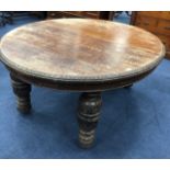 A STAINED OAK OVAL EXTENDING DINING TABLE