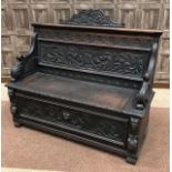 A CARVED OAK HALL SETTLE