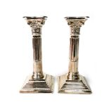 A PAIR OF SILVER CORINTHIAN PILLAR CANDLESTICKS