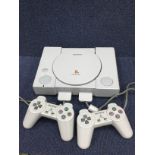 A SONY PLAYSTATION GAMES CONSOLE AND ACCESSORIES