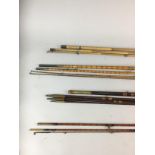 A GROUP OF SPLIT CANE, GREENHEART AND BAMBOO FISHING RODS