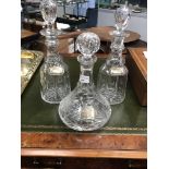 THREE CRYSTAL DECANTERS WITH SILVER LABELS