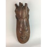 AN AFRICAN WOOD WALL MASK