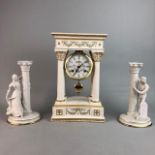 A REPRODUCTION CERAMIC CLOCK AND A PAIR OF CANDLESTICKS