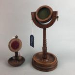 TWO TURNED WOODEN WATCH STANDS AND A STAFFORDSHIRE WATCH STAND