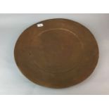 A MID 20TH CENTURY WEST AFRICAN HAMMERED METAL CIRCULAR DISH