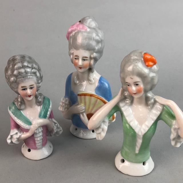 A COLLECTION OF HALF DOLL FIGURES