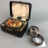 FOUR SILVER NAPKIN RINGS AND A PLATED BRUSH SET