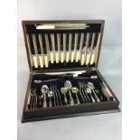 A WALNUT CASED CANTEEN OF SILVER PLATED CUTLERY