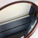 TWO STAINED WOOD OVAL MIRRORS