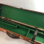 A WOOD AND BRASS BOUND GUN CASE AND A LEATHER GUN CASE