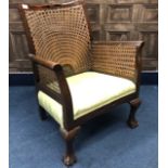 A CANE BACK FIRESIDE ARMCHAIR