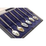 A SET OF SIX SILVER AND FLORAL ENAMEL TEASPOONS