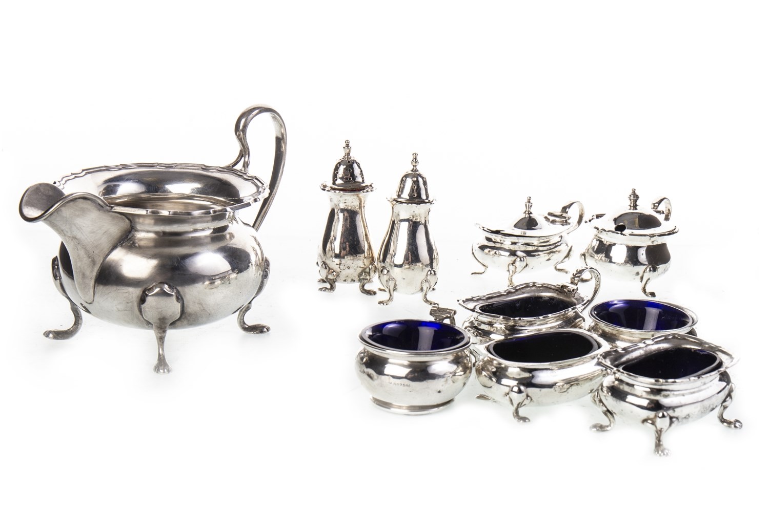 A SILVER CRUET SET AND A SILVER SAUCE BOAT