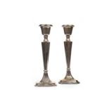 A PAIR OF GEORGE V SILVER CANDLESTICKS