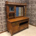 AN ARTS & CRAFTS OAK MIRROR BACKED SIDEBOARD