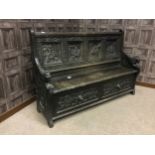 A VICTORIAN CARVED OAK SETTLE