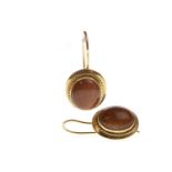 A PAIR OF GOLDSTONE SET EARRINGS