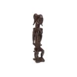 AN AFRICAN CARVED WOOD FIGURE OF A FEMALE WITH CHILD