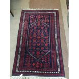 A LARGE RED KESHAN RUG