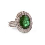 AN EMERALD AND DIAMOND CLUSTER RING