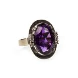 A PURPLE GEM SET AND DIAMOND RING