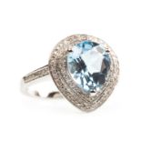 A PEAR SHAPED BLUE TOPAZ AND DIAMOND RING