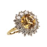 A YELLOW TOPAZ AND DIAMOND RING