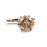 A COGNAC DIAMOND SOLITAIRE RING