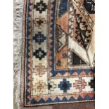 A MIDDLE EASTERN FRINGED CARPET
