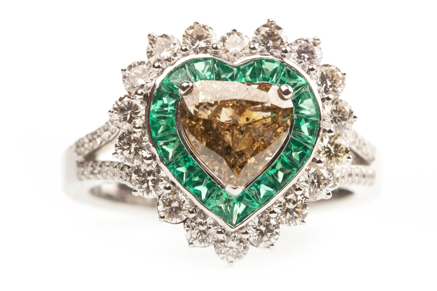 AN IMPRESSIVE HEART SHAPED DIAMOND AND EMERALD RING