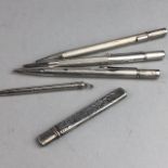 THREE SILVER PROPELLING PENCILS AND TWO OTHERS