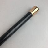 A NINE CARAT GOLD TOPPED EBONISED WALKING CANE