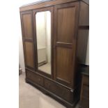 A MAHOGANY THREE DOOR WARDROBE AND A MATCHING CHEST OF DRAWERS