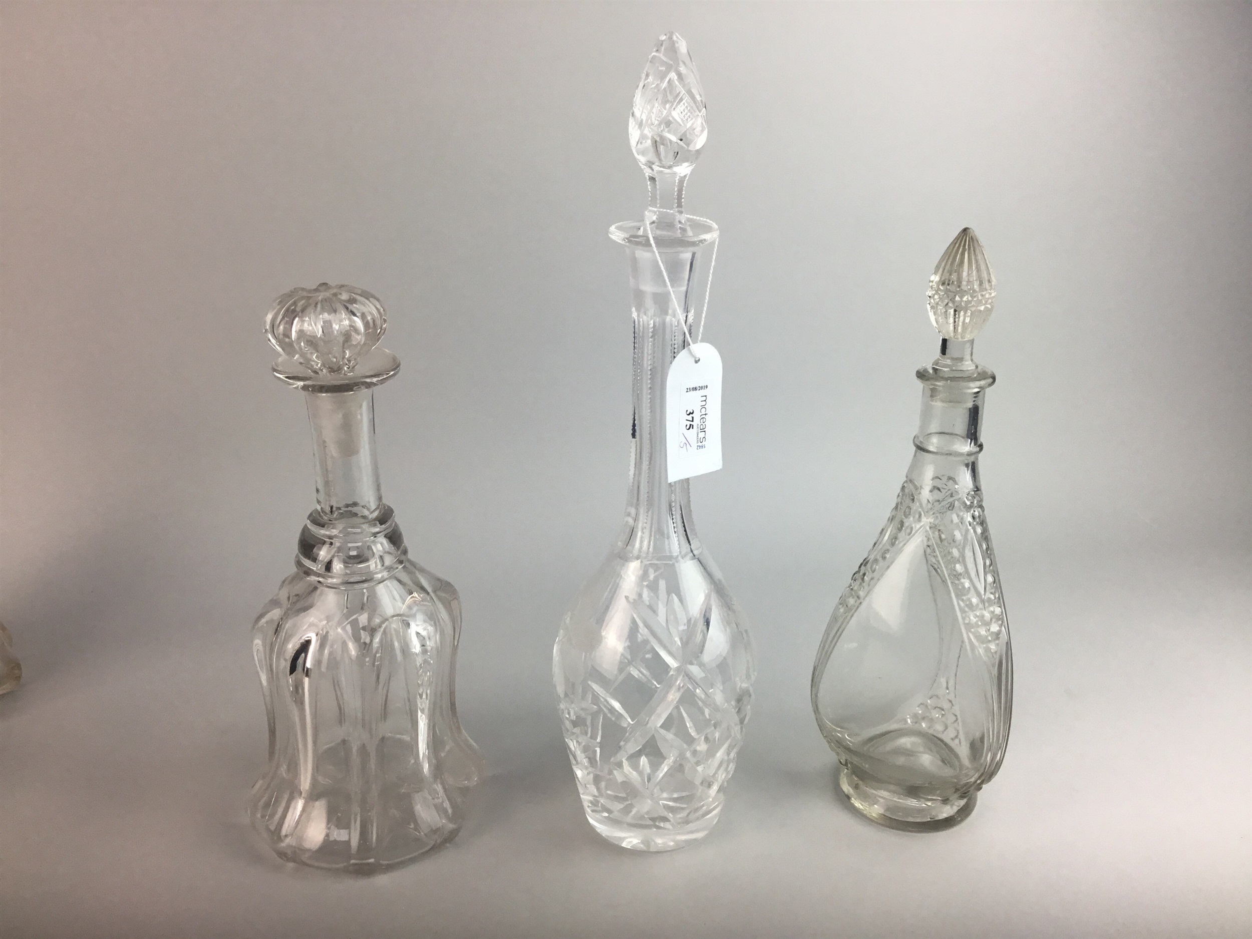 FIVE CRYSTAL DECANTERS WITH STOPPERS