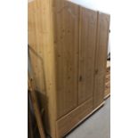 A PINE EFFECT WARDROBE AND A CHEST OF DRAWERS