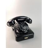 A VINTAGE BLACK BAKELITE TELEPHONE AND ANOTHER