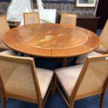 A DANISH CIRCULAR EXTENDING DINING TABLE AND EIGHT CHAIRS