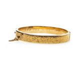 A NINE CARAT GOLD BANGLE